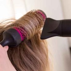 a-girl-with-blonde-hair-dries-her-hair-with-drier-2024-11-27-20-19-03-utc