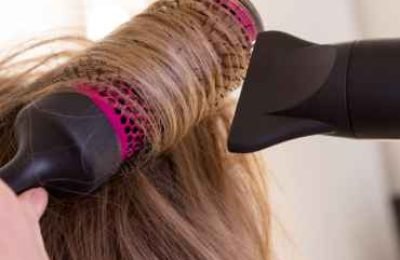 a-girl-with-blonde-hair-dries-her-hair-with-drier-2024-11-27-20-19-03-utc