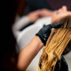 close-up-of-a-hairdresser-applying-paint-to-a-clie-2024-11-26-20-19-43-utc