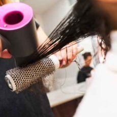 close-up-of-female-hand-holding-hairdryer-2025-03-08-02-55-33-utc