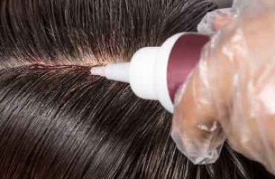 hair-dresser-applying-chemical-hair-color-dye-onto-2025-03-10-01-04-58-utc