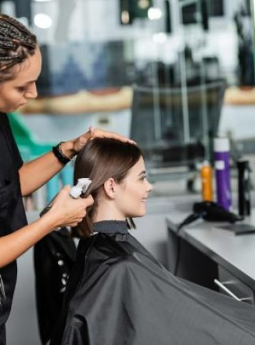 hairstylist-spraying-hair-of-female-client-hairdre-2024-11-09-03-30-16-utc (1)